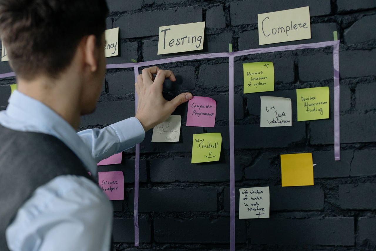 Person arranging project notes on a planning board