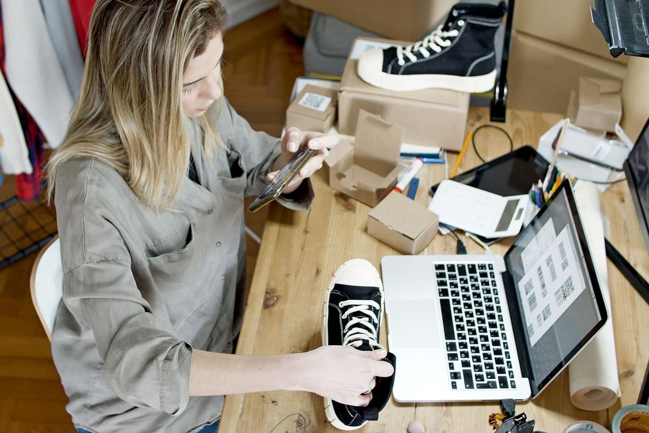 Woman photographing a product for an online business