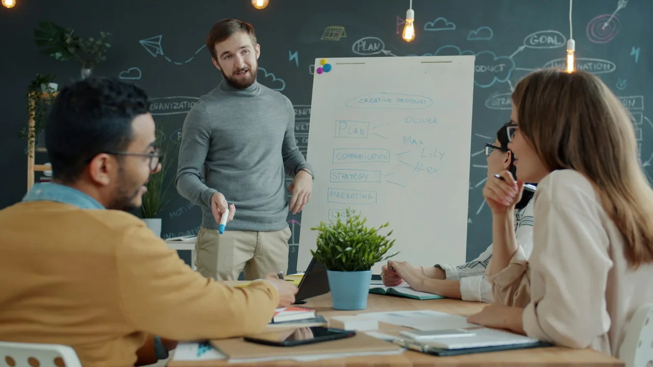 People discussing a plan at a whiteboard in an office