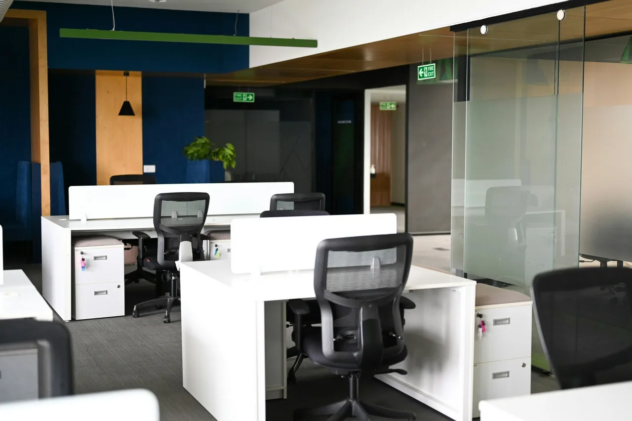 Modern office interior with desks and black chairs